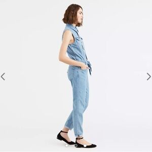 Levi’s taper leg jumpsuit with belt and buttons all the way down the front.